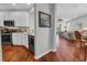 Bright living room with hardwood floors is shown from a perspective of a kitchen corner at 2064 Batello Dr, Venice, FL 34292