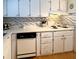 Bright kitchen offering white cabinets, updated countertops and backsplash, and sleek appliances at 217 Water Oak Ln, Sarasota, FL 34237