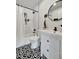 Bathroom featuring a shower/tub with subway tile, a black showerhead, modern fixtures, and patterned floors at 229 42Nd W St, Bradenton, FL 34209