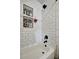 A detailed shot of the bathtub area in the bathroom with white subway tile and black trim at 229 42Nd W St, Bradenton, FL 34209