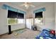 A cozy bedroom with a ceiling fan, two windows, a white dresser and carpet flooring at 229 42Nd W St, Bradenton, FL 34209