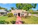 Charming single-Gathering home showcasing a quaint exterior with a red tile walkway and well-maintained lawn at 229 42Nd W St, Bradenton, FL 34209