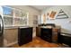 Kitchen with black appliances, terracotta tile floor, and ample cabinet space at 229 42Nd W St, Bradenton, FL 34209