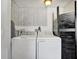 Laundry room featuring a washer and dryer with a decorative wall and a folding door at 229 42Nd W St, Bradenton, FL 34209