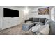 Cozy living room features a plush gray sectional sofa, modern entertainment center, and carpeted floors at 229 42Nd W St, Bradenton, FL 34209