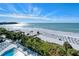 Stunning aerial view highlighting the beautiful white sand beach and inviting pool area at 230 Sands Point Rd # 3501, Longboat Key, FL 34228
