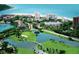 Stunning aerial view of a resort featuring a golf course, beach, and waterfront buildings, perfect for a luxurious getaway at 230 Sands Point Rd # 3501, Longboat Key, FL 34228