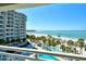 Large balcony overlooking the beach, pool, and ocean waters at 230 Sands Point Rd # 3501, Longboat Key, FL 34228