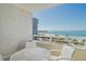 Balcony view of ocean and beach with seating, creating an inviting outdoor retreat with stunning scenery at 230 Sands Point Rd # 3501, Longboat Key, FL 34228