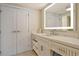 Elegant bathroom with a large illuminated mirror, neutral tones, and ample storage at 230 Sands Point Rd # 3501, Longboat Key, FL 34228
