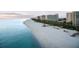 Scenic beach view with turquoise ocean water and modern condo buildings in the background at sunset along the coastline at 230 Sands Point Rd # 3501, Longboat Key, FL 34228