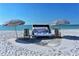 Inviting beach setup with cabana, chairs, and umbrellas on pristine white sand with beautiful ocean views at 230 Sands Point Rd # 3501, Longboat Key, FL 34228