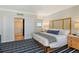 Bedroom with light colored walls, accent furniture, and entrance to bathroom via sliding door at 230 Sands Point Rd # 3501, Longboat Key, FL 34228