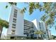 Building Three boasts tropical landscaping, bright white facade, and multiple private balconies at 230 Sands Point Rd # 3501, Longboat Key, FL 34228