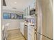Efficient kitchen with stainless steel appliances, white cabinets, and modern decor at 230 Sands Point Rd # 3501, Longboat Key, FL 34228