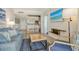Comfortable living room featuring stylish blue accents and a flat-screen TV with beach view at 230 Sands Point Rd # 3501, Longboat Key, FL 34228