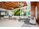 Modern lobby with comfortable seating, wood ceiling, a living plant wall, and large windows overlooking the green landscape at 230 Sands Point Rd # 3501, Longboat Key, FL 34228