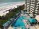 An elevated angle of the community pool and hot tub area adjacent to the beach at 230 Sands Point Rd # 3501, Longboat Key, FL 34228