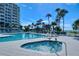A pool and hot tub with a condo building and the beach in the background at 230 Sands Point Rd # 3501, Longboat Key, FL 34228
