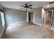 Large primary bedroom features a ceiling fan, closet, light-colored walls, and stylish wood-look flooring at 2309 30Th W Ave, Bradenton, FL 34205