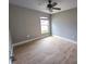 Spacious bedroom with a ceiling fan, light-colored walls, and stylish wood-look tile flooring at 2309 30Th W Ave, Bradenton, FL 34205