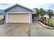 Charming single-story house featuring a one-car garage, complemented by a neat front yard with lush greenery and walkway at 2309 30Th W Ave, Bradenton, FL 34205