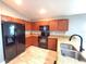 Modern kitchen with stainless steel appliances, wood cabinets, and granite countertops, offering ample space and functionality at 2309 30Th W Ave, Bradenton, FL 34205