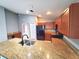 Open kitchen featuring stainless steel appliances, a breakfast bar, and wood cabinets, perfect for modern living and entertaining at 2309 30Th W Ave, Bradenton, FL 34205