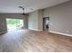 Bright living room with wood-look floors and a sliding glass door leading to a patio, seamlessly blending indoor and outdoor spaces at 2309 30Th W Ave, Bradenton, FL 34205