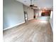 Open-concept living space with wood-look flooring, seamlessly flowing into the kitchen, creating an inviting atmosphere at 2309 30Th W Ave, Bradenton, FL 34205