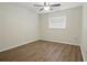 This bedroom features a ceiling fan and wood-look laminate flooring at 23116 Amethyst Ave, Port Charlotte, FL 33952