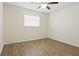 Bedroom with a ceiling fan and laminate flooring at 23116 Amethyst Ave, Port Charlotte, FL 33952