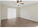 Bedroom with wood-look flooring, a ceiling fan, a sliding glass door and lots of natural light at 23116 Amethyst Ave, Port Charlotte, FL 33952