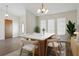 Dining room with stylish light fixture, and a table set for six, illuminated by natural light at 23116 Amethyst Ave, Port Charlotte, FL 33952