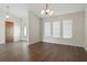 Dining room features wood-look flooring, modern lighting, neutral walls, and multiple windows for natural light at 23116 Amethyst Ave, Port Charlotte, FL 33952