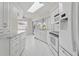 Bright kitchen features white cabinetry, a skylight, updated appliances, and a window over the sink at 23116 Amethyst Ave, Port Charlotte, FL 33952