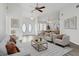Bright living room featuring vaulted ceilings, modern decor, and a neutral color palette at 23116 Amethyst Ave, Port Charlotte, FL 33952