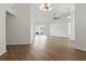 Spacious living room with vaulted ceilings, ceiling fan, wood-look floors, and sliding glass doors at 23116 Amethyst Ave, Port Charlotte, FL 33952