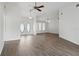 Bright living room boasts wood-look flooring, ceiling fan, and a front door with an oval glass insert at 23116 Amethyst Ave, Port Charlotte, FL 33952