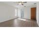 Bedroom with wood-look flooring, ceiling fan, natural light, and an ensuite bathroom at 23116 Amethyst Ave, Port Charlotte, FL 33952