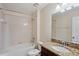 Bathroom features a tub with shower, toilet and granite vanity with dark cabinets at 2332 Dovesong Trace Dr, Ruskin, FL 33570