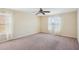 Neutral bedroom with plush carpet and two windows with decorative curtains and blinds at 2332 Dovesong Trace Dr, Ruskin, FL 33570