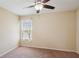 Neutral bedroom featuring plush carpet, a ceiling fan, and a window with white coverings at 2332 Dovesong Trace Dr, Ruskin, FL 33570