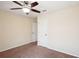 Bedroom featuring neutral walls, plush carpet, ceiling fan, and an entrance to another room at 2332 Dovesong Trace Dr, Ruskin, FL 33570