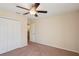 Bedroom with a ceiling fan, neutral walls, carpeted floor, a closet and white doors and trim at 2332 Dovesong Trace Dr, Ruskin, FL 33570