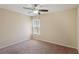 Neutral bedroom featuring plush carpet, a ceiling fan, and a window with coverings at 2332 Dovesong Trace Dr, Ruskin, FL 33570