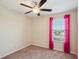 Bedroom featuring a window with pink curtains, neutral walls, carpeted floor, and a ceiling fan at 2332 Dovesong Trace Dr, Ruskin, FL 33570