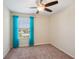 Bedroom featuring a ceiling fan, a window with turquoise curtains, neutral walls, and carpeted floor at 2332 Dovesong Trace Dr, Ruskin, FL 33570