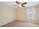 Bedroom featuring neutral walls, carpeted floor, and a window with sheer curtains at 2332 Dovesong Trace Dr, Ruskin, FL 33570