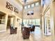 Clubhouse lobby with high ceilings, comfortable seating, and view of the pool at 2332 Dovesong Trace Dr, Ruskin, FL 33570